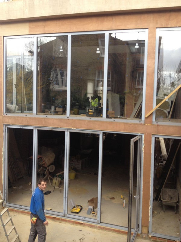 Aluminium bi-fold doors with two-storey glazing in Hanwell