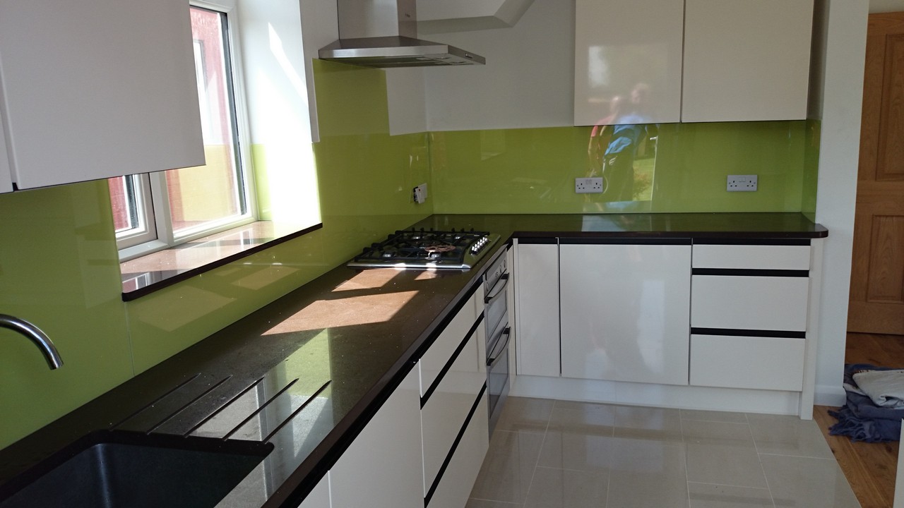 Lime green glass kitchen splashback installed by Hanwell glaziers